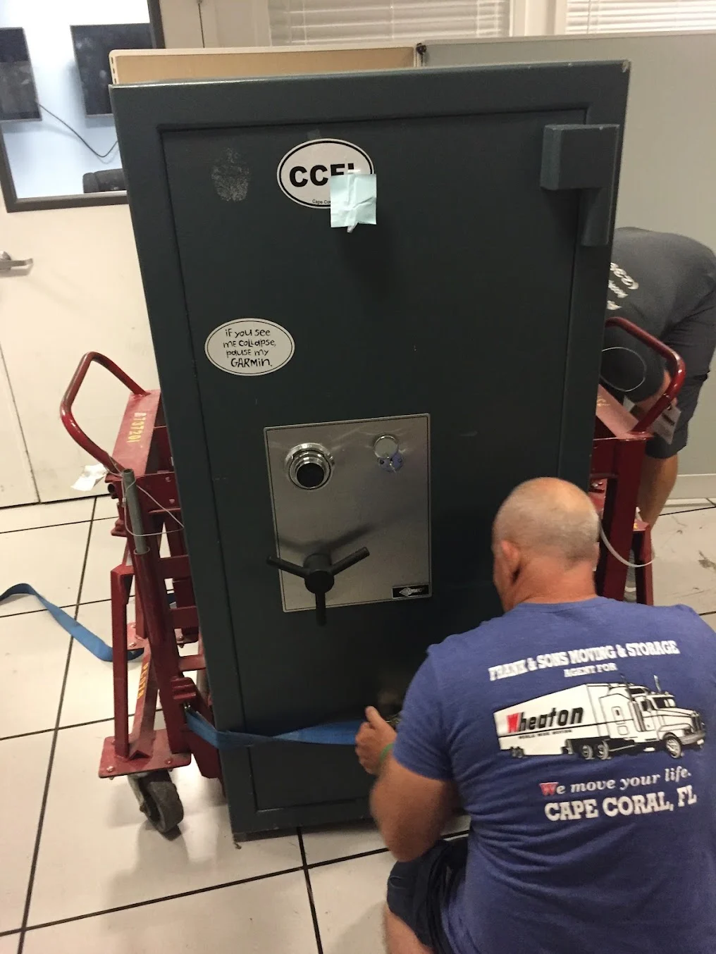 Frank and Sons crew preparing a large safe on moving equipment