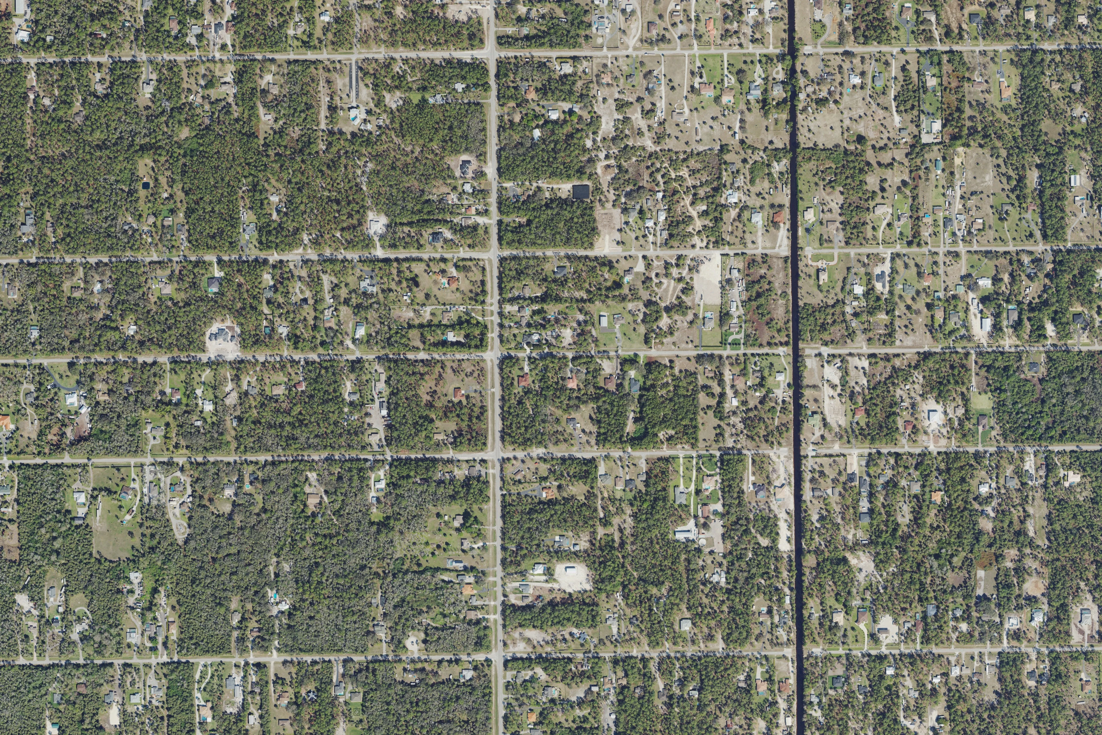 Aerial view of Golden Gate Estates homes on wooded lots near Wilson Boulevard