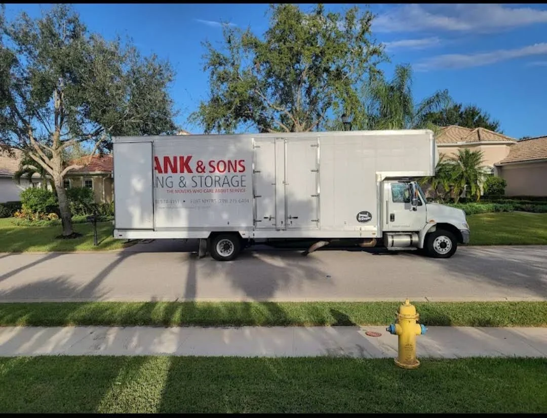 Frank and Sons moving truck parked along a residential street
