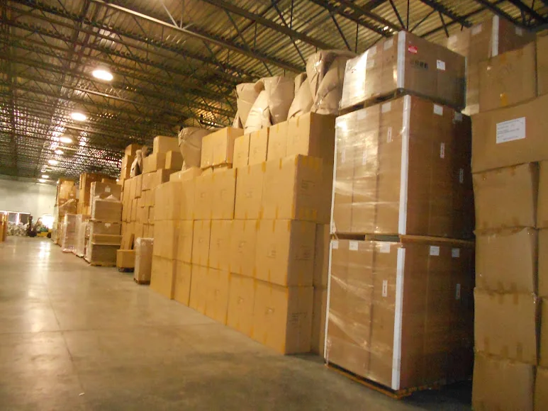 Rows of labeled wooden storage crates inside a company warehouse