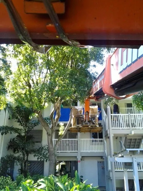 A lift positioned beside balconies during a furniture move