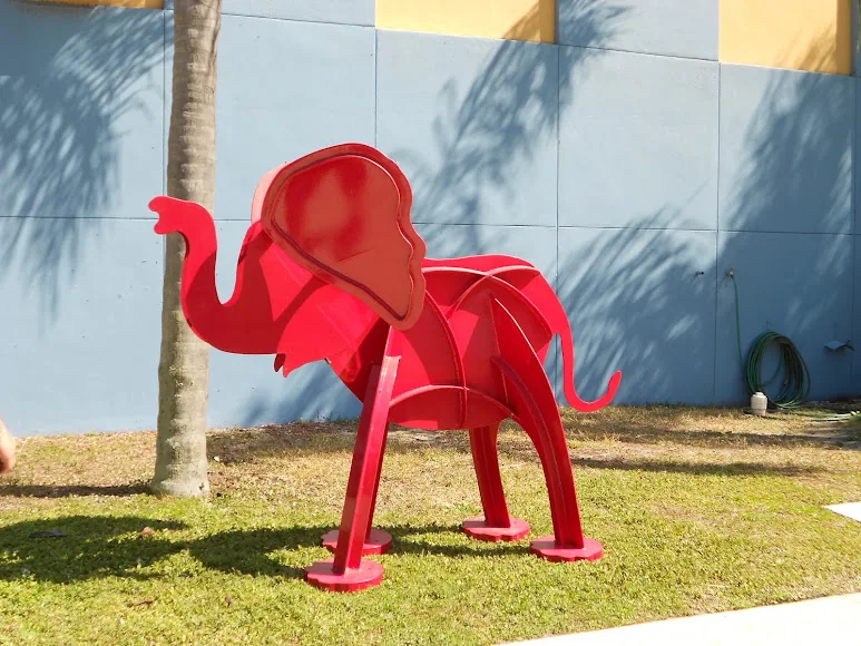 A red elephant shaped sculpture from the company photo collection