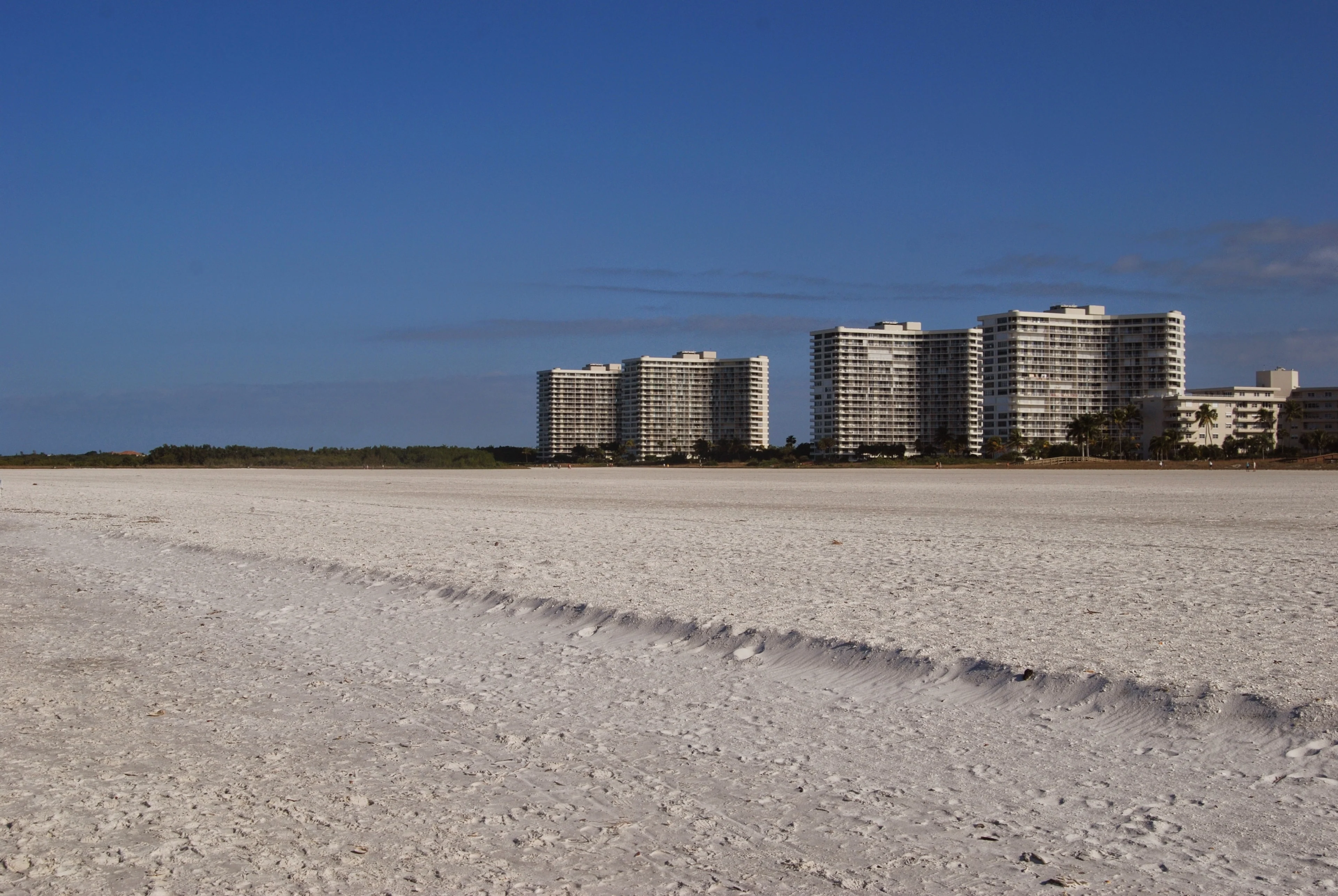 Wide sandy beach and beachfront condominium towers on Marco Island