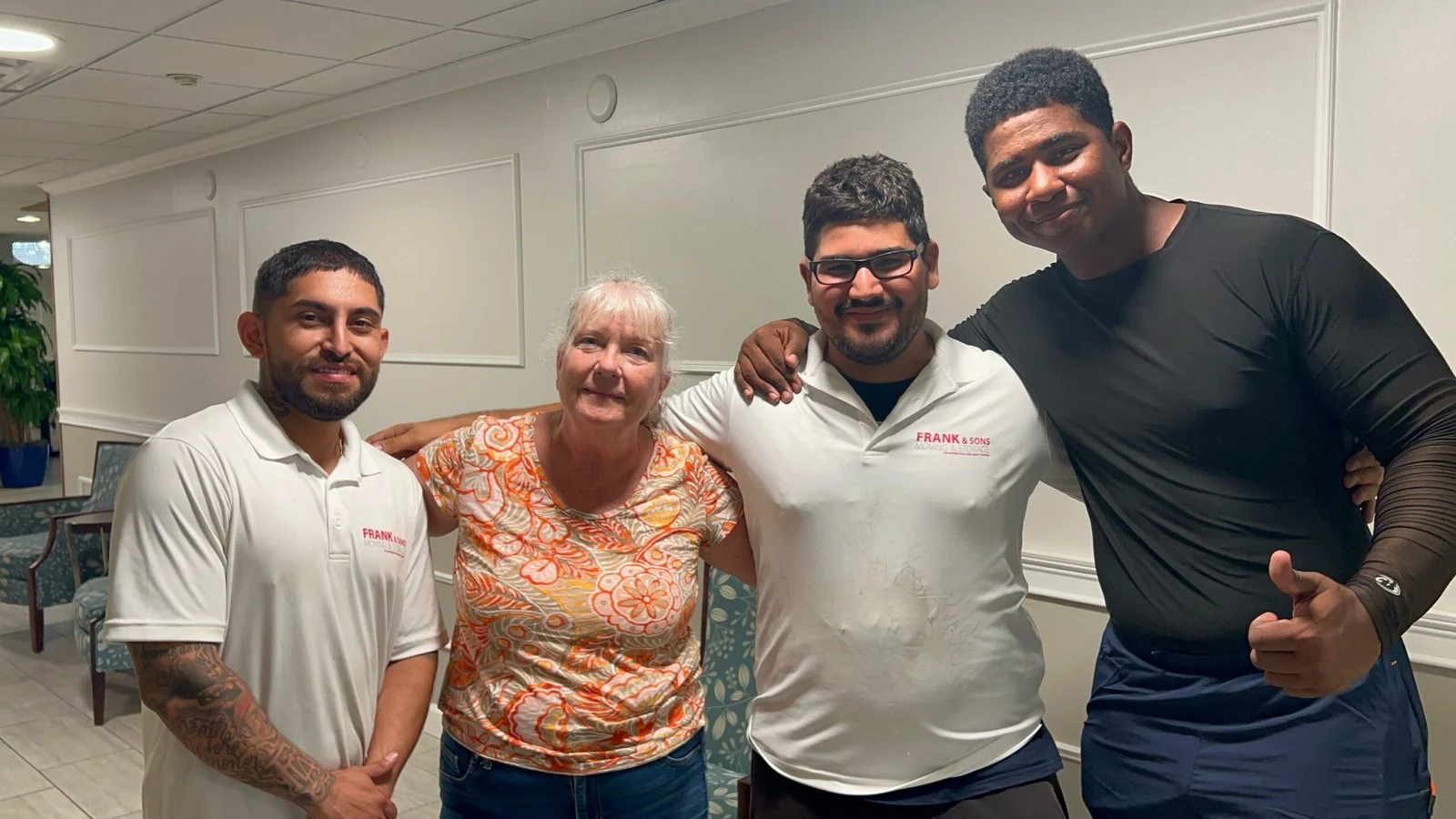 Frank and Sons moving crew standing with a customer