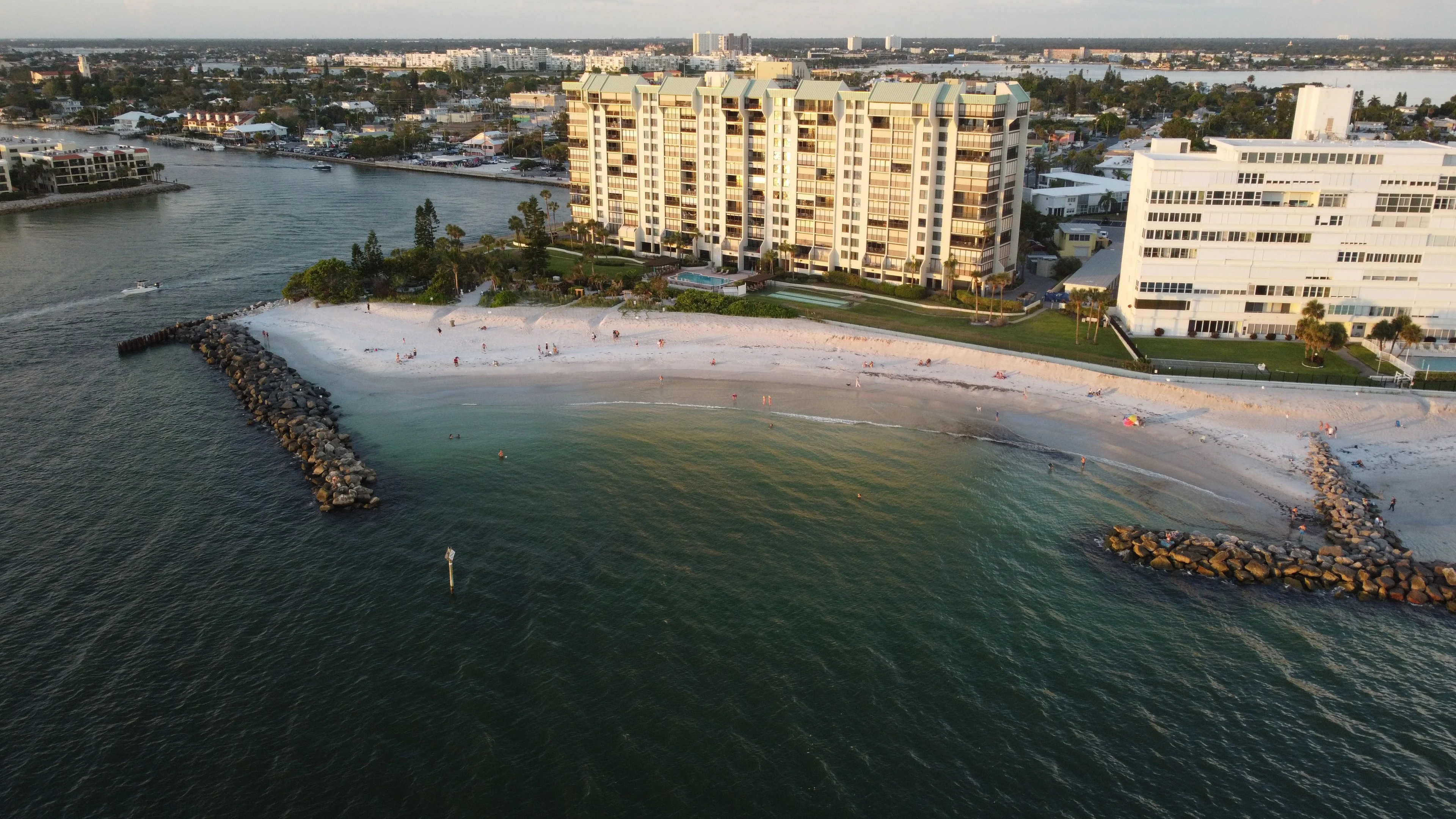 Naples beachfront condominium buildings beside the Gulf and a rocky inlet
