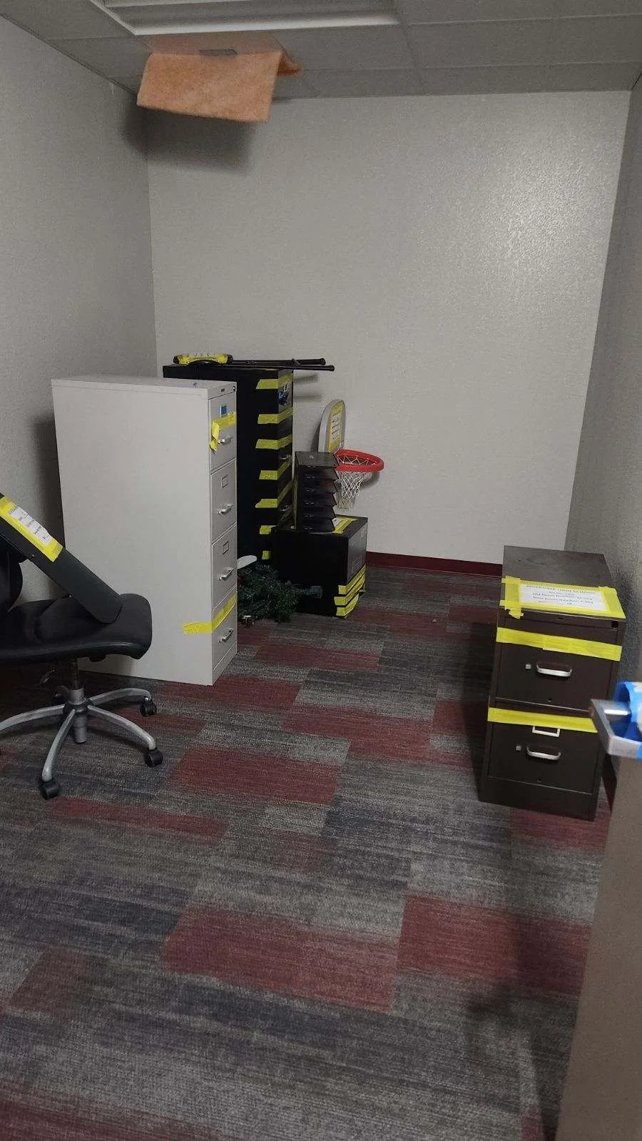 Filing cabinets and office equipment labeled for a move