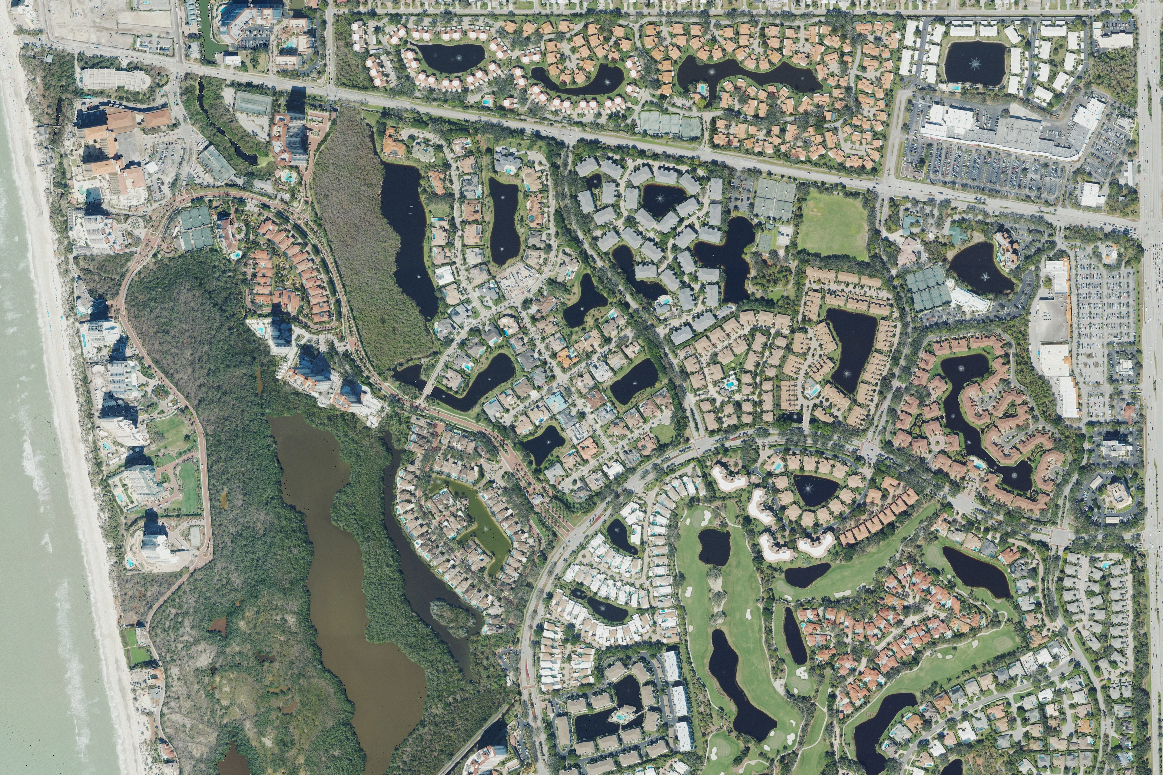 Aerial view of northern Pelican Bay neighborhoods and coastal waterways